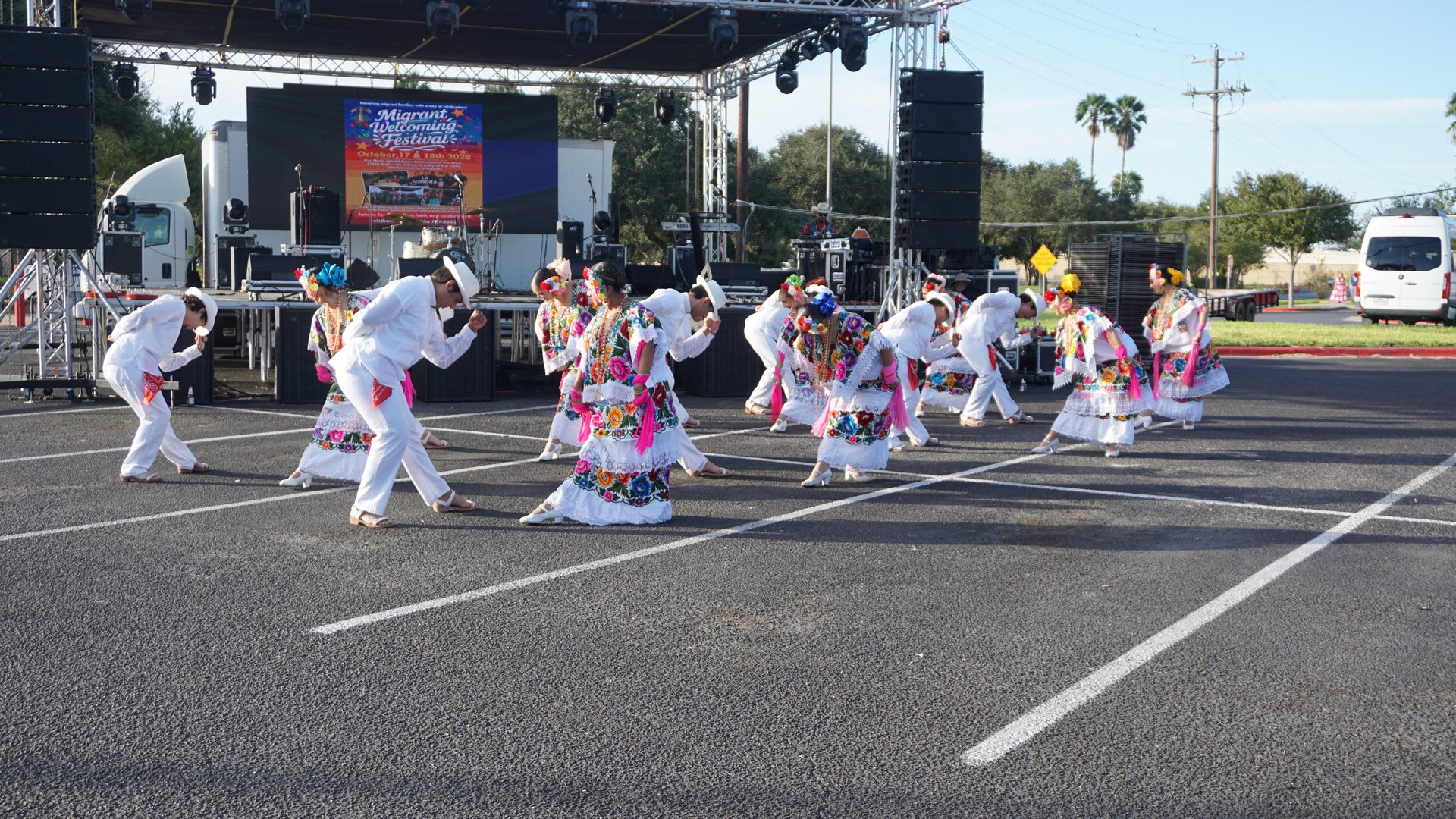 Rows of dancers lift their feet during a coordinated festival performance.