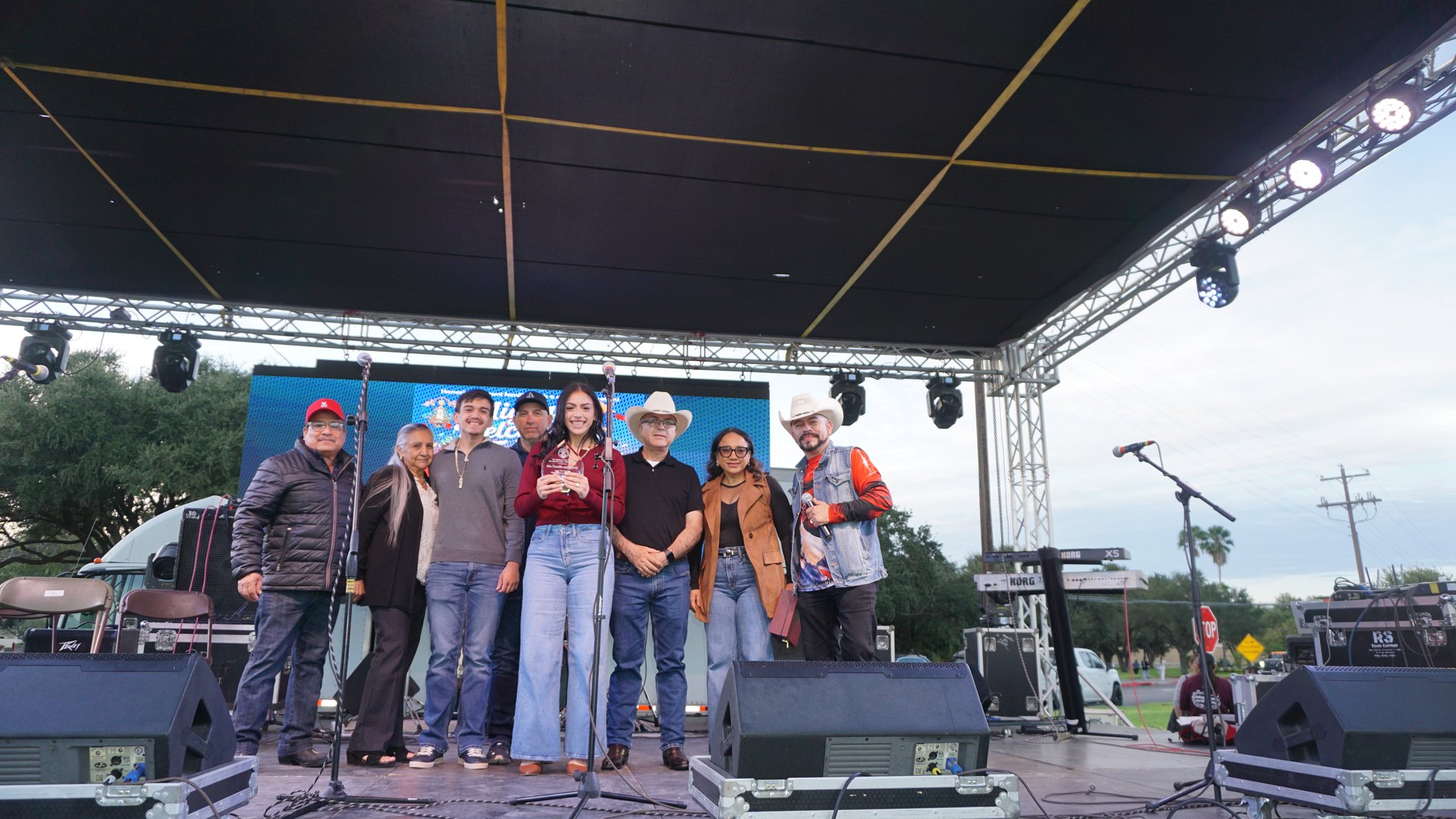Festival guests line up for a group photo on the covered stage.